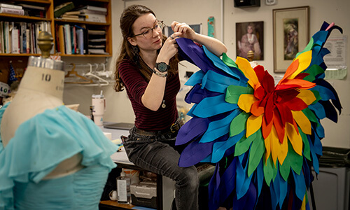 WSU student creating costume in theatre depeartment.