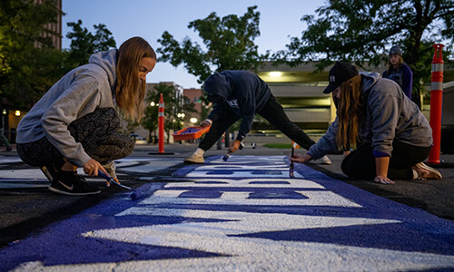 WSU students painting WSU Logo on street.