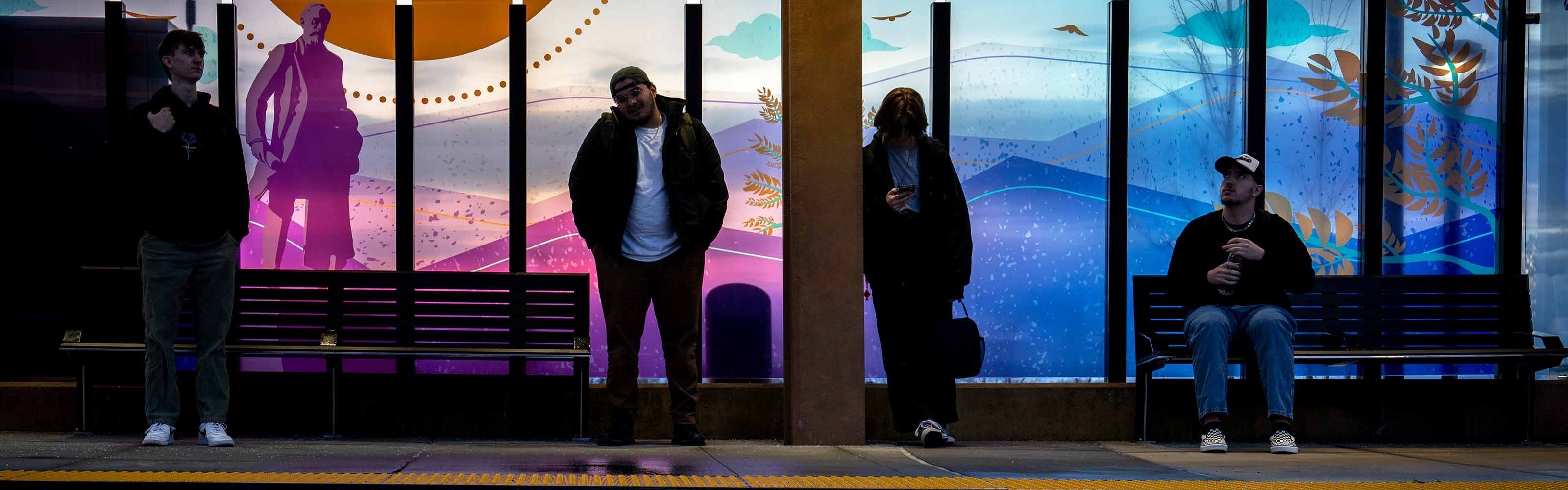 WSU students waiting at bus stop on campus.